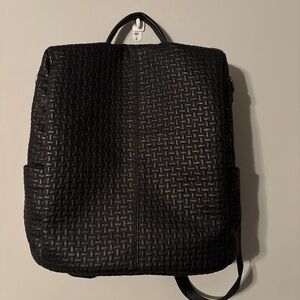 Small woman’s anti- theft black backpack with adjustable straps.